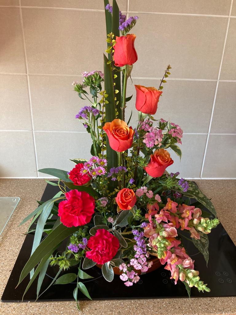 Flower arrangement tall with red roses